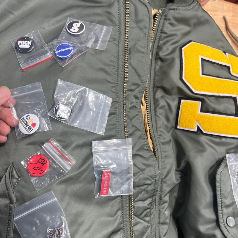 Supreme Brand Jacket with Custom Pins and Accessories